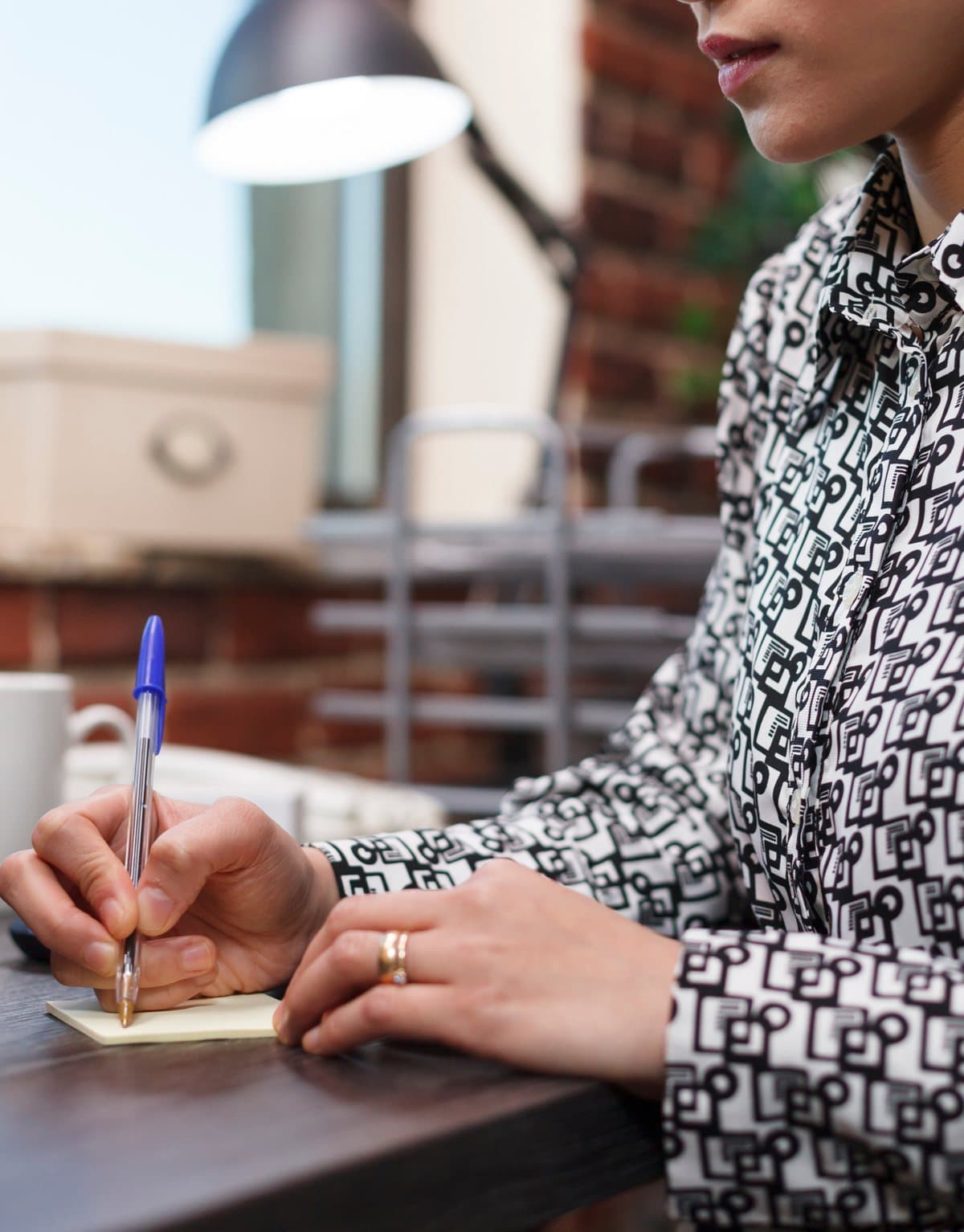 A woman writing a card at her desk
